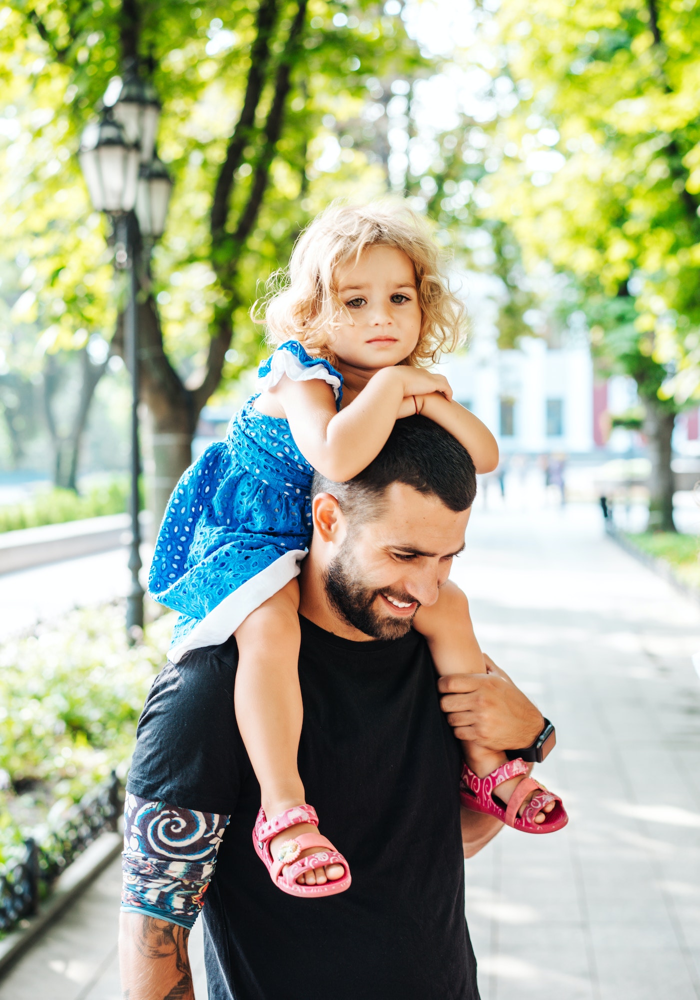 little girl riding on dads neck